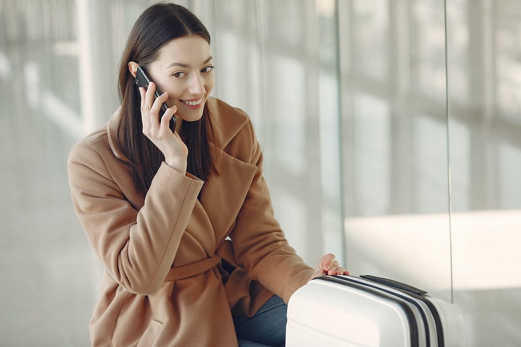 property-manager-for-airbnb-pretty-woman-talking-on-smartphone-in-airport-customer-service-airbnb-guest
