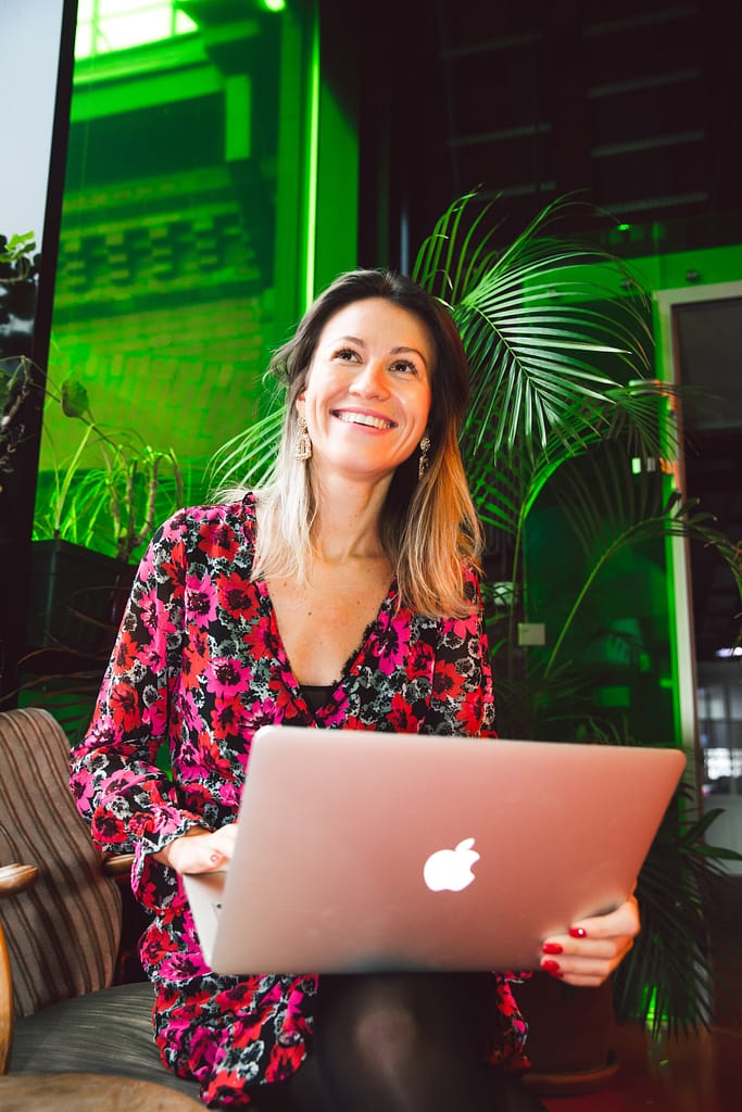 airbnb-management-company-london-woman-laugh-smile-laptop-happy-landlord
