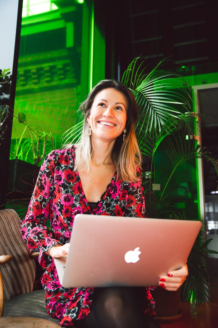 property-manager-for-airbnb-management-company-london-woman-laugh-smile-laptop-happy-landlord